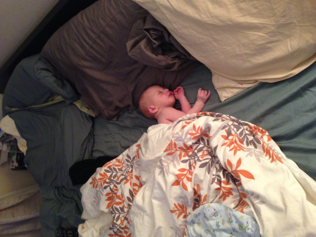 Our newborn on our king size bed