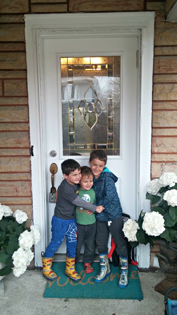 breath three boys in front of house